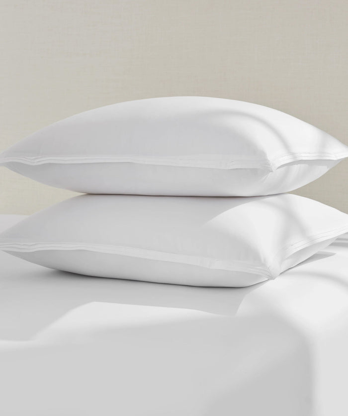 Two stacked white percale euro shams.