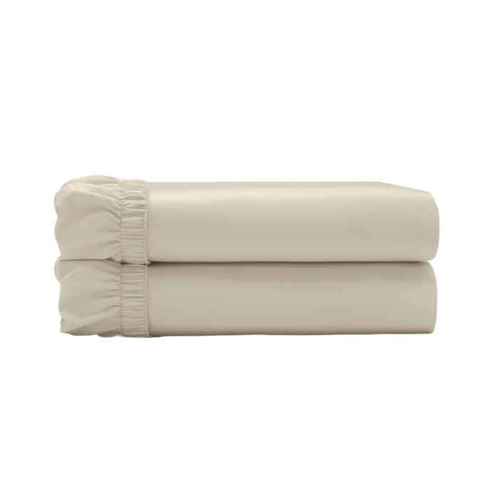 Two beige fitted sheets folded and stacked.