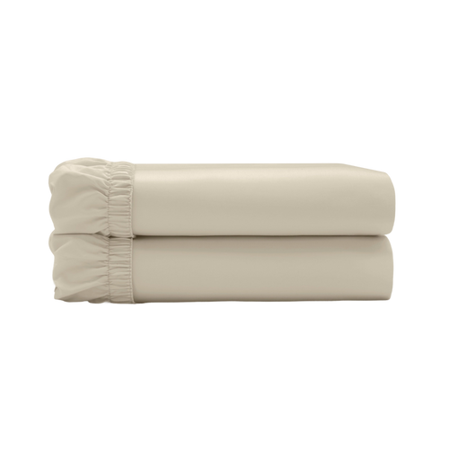 Two beige fitted sheets folded and stacked.