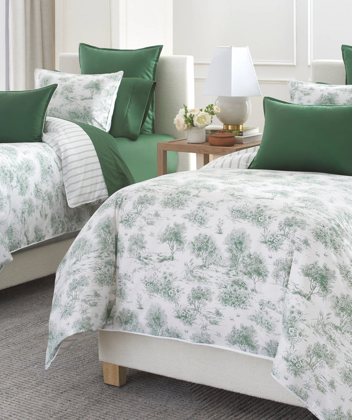 Green garden toile duvet cover set styled on a bed.