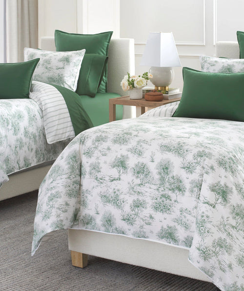 Green garden toile duvet cover set styled on a bed.